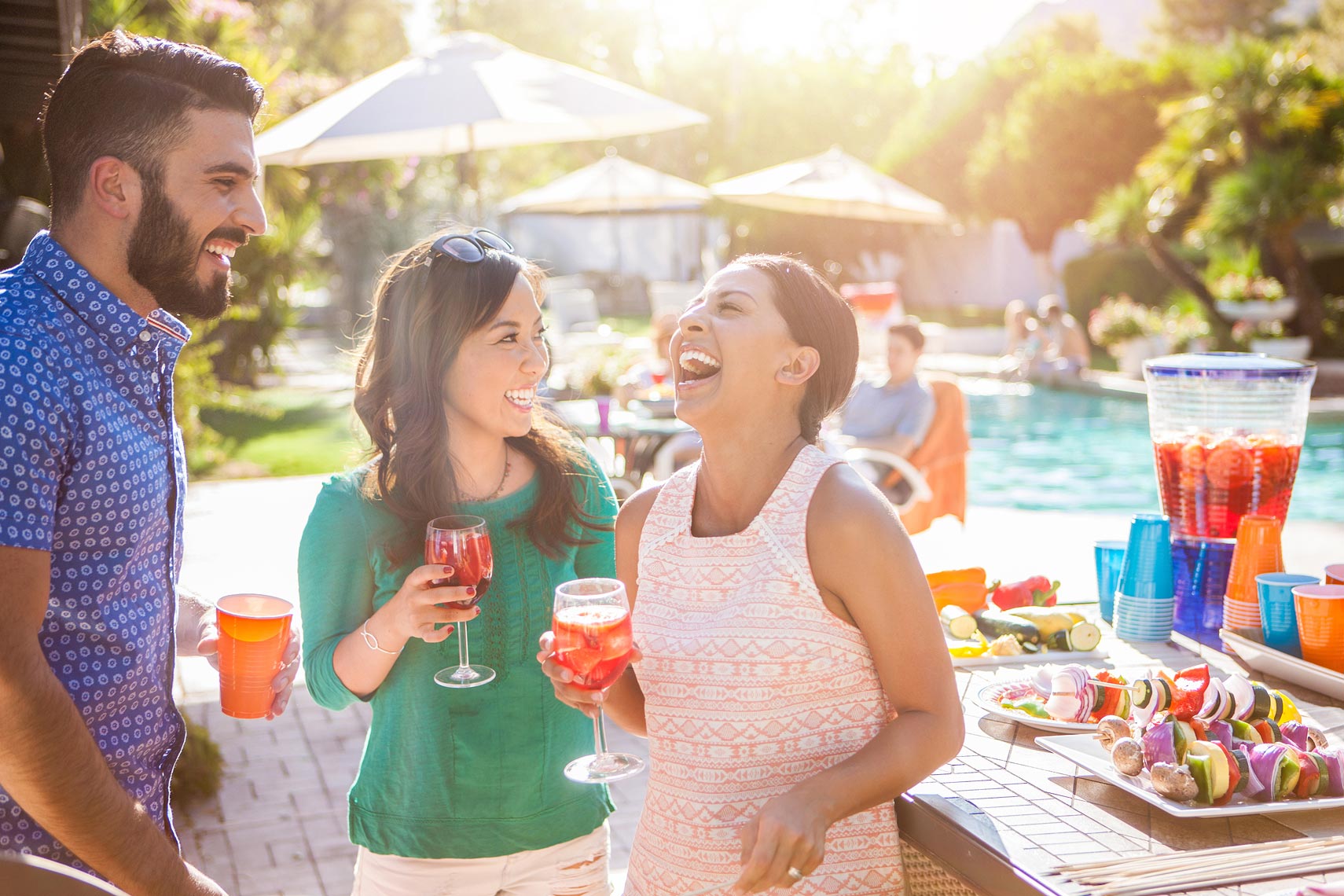 Friends laughing at a backyard pool party | OneAZ | John Fedele Lifestyle Photography