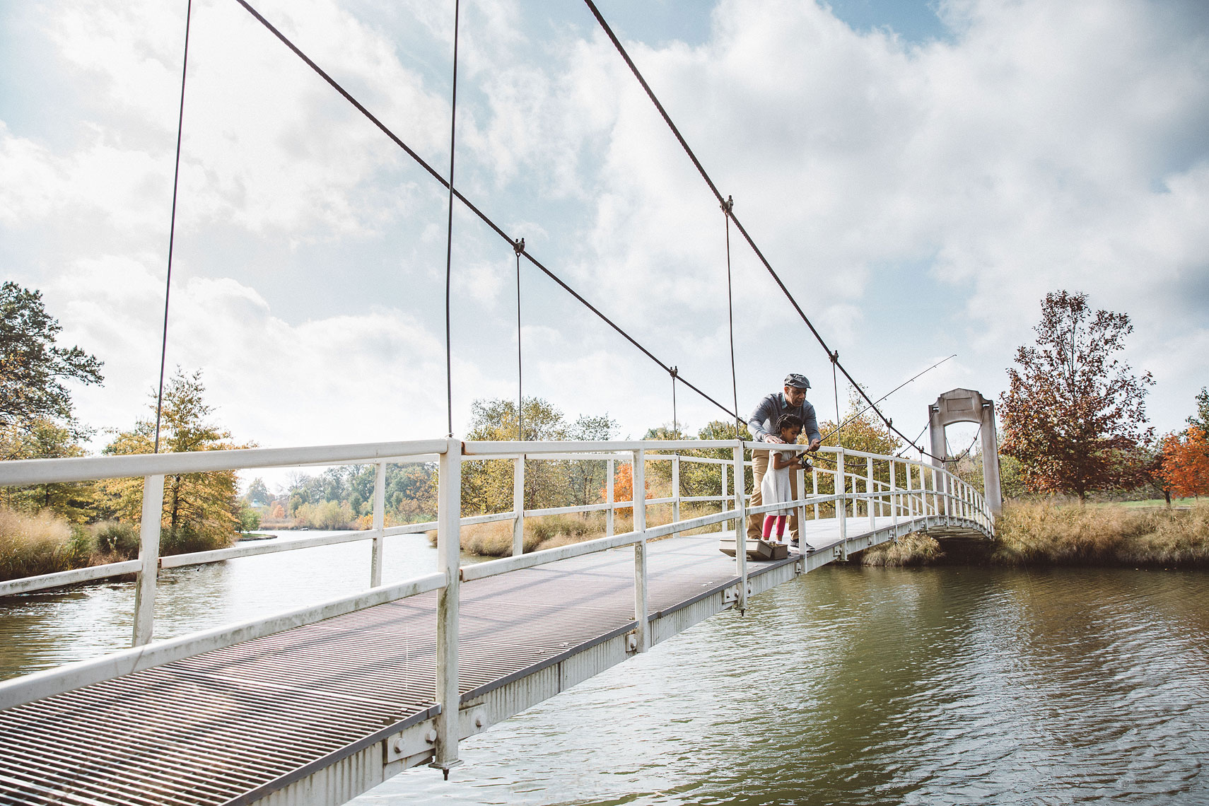 Grandfather and granddaughter fishing off a bridge |  Centene | John Fedele Lifestyle Photography