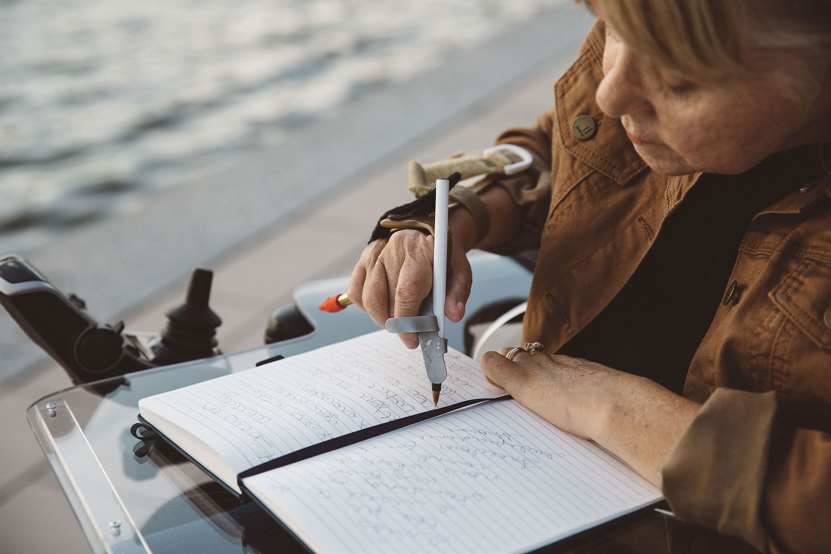 Women writing with assistance  | Centene | John Fedele Lifestyle Photography