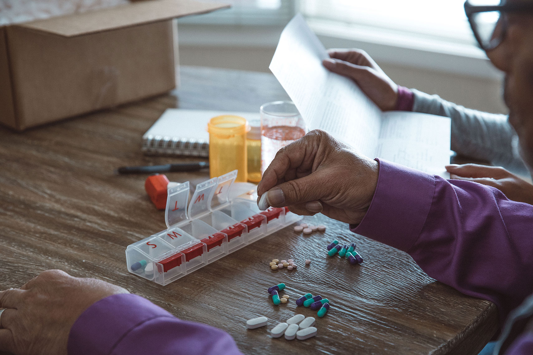 Sorting medications in a pillbox |  Centene | John Fedele Lifestyle Photography