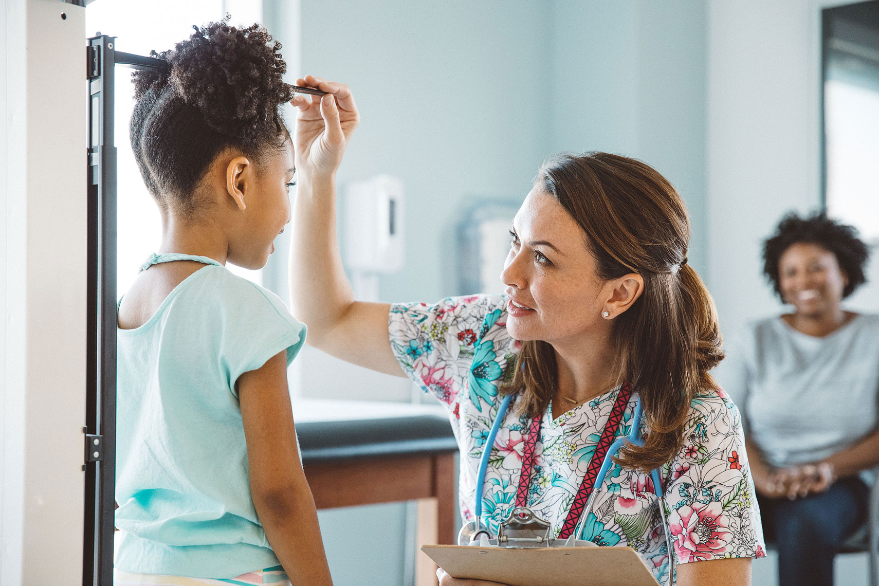 Nurse measuring the height of a young patient |  Centene | John Fedele Lifestyle Photography