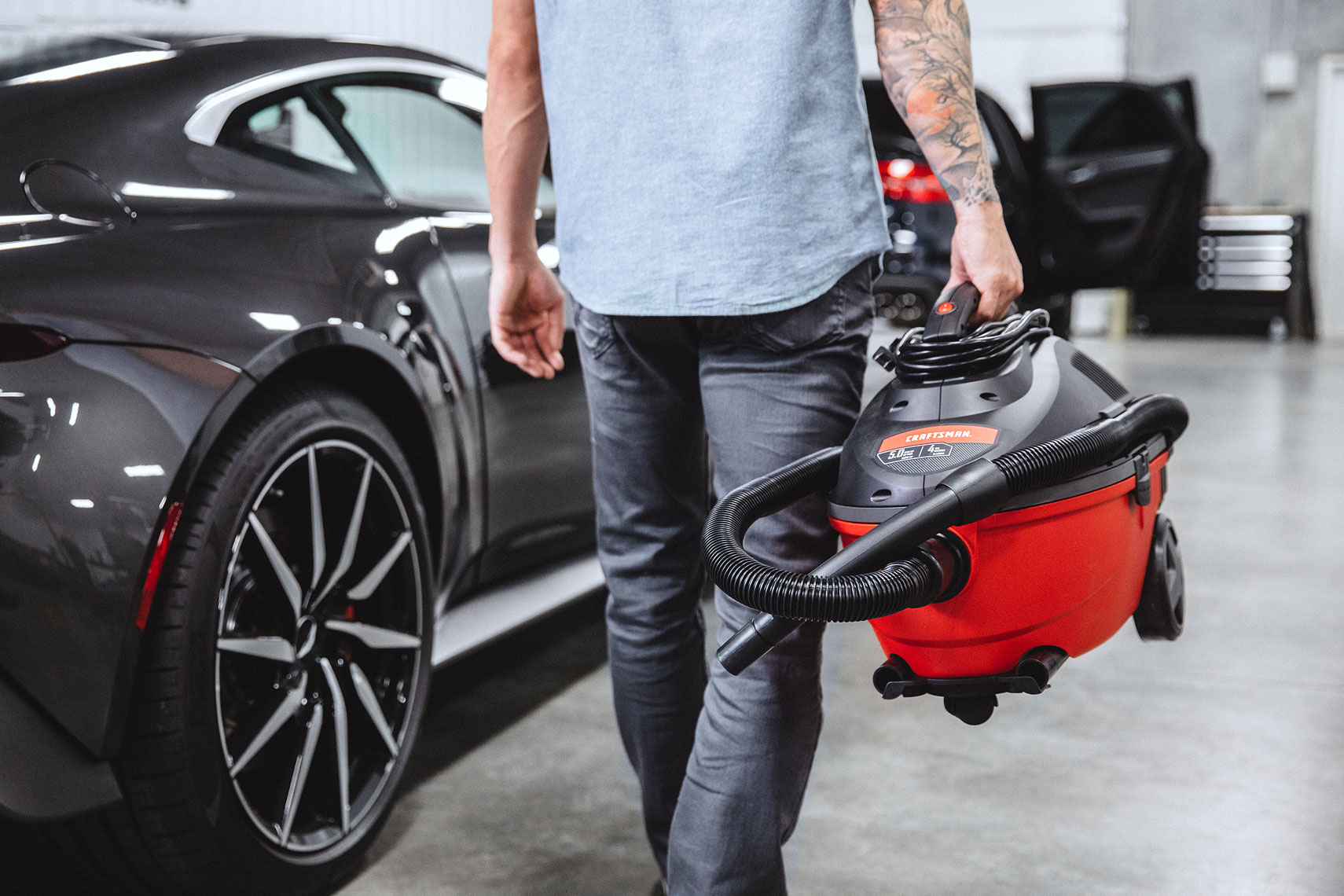 Craftsman Tools 4 Gallon Wet/Dry Vacuum | Mechanic walking near cars in garage. | John Fedele Product Photography
