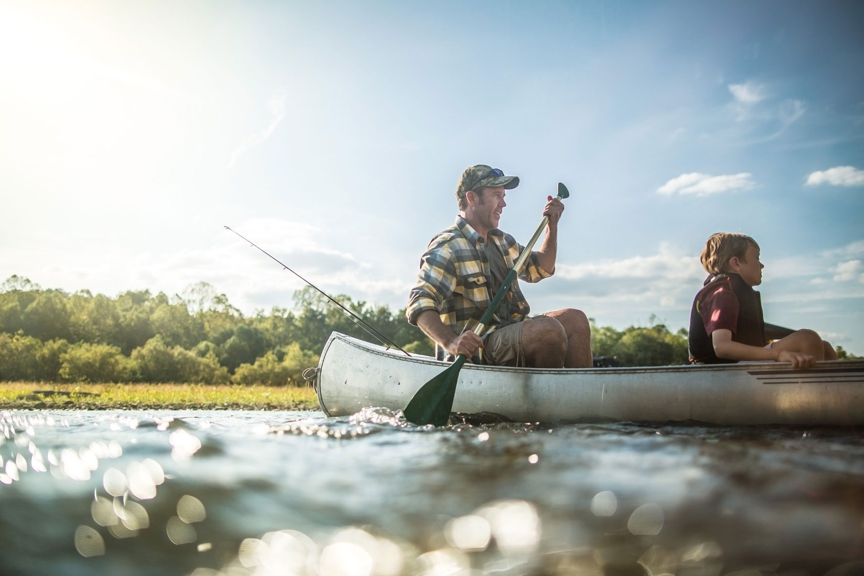Father and son in a canoe on the river.  | John Fedele Lifestyle Photography