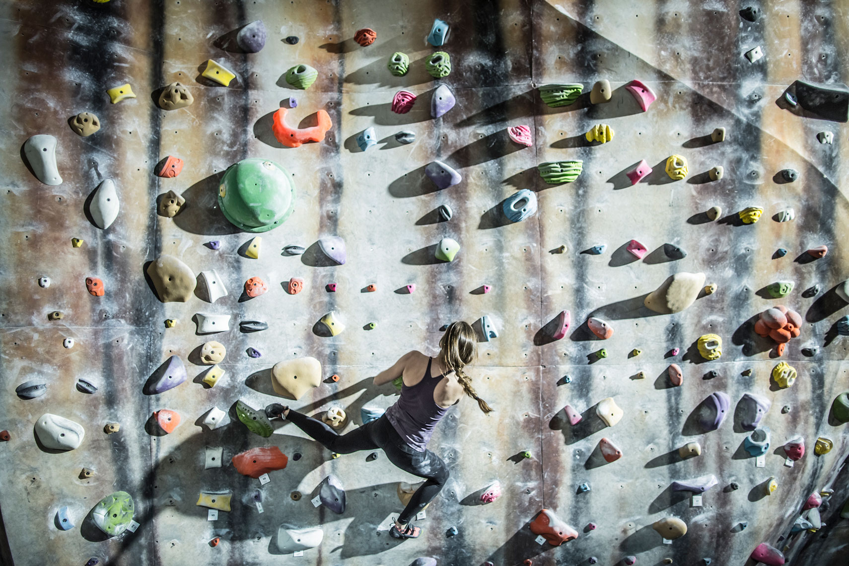 Woman climbing at a climbing gym. | John Fedele Lifestyle Photography