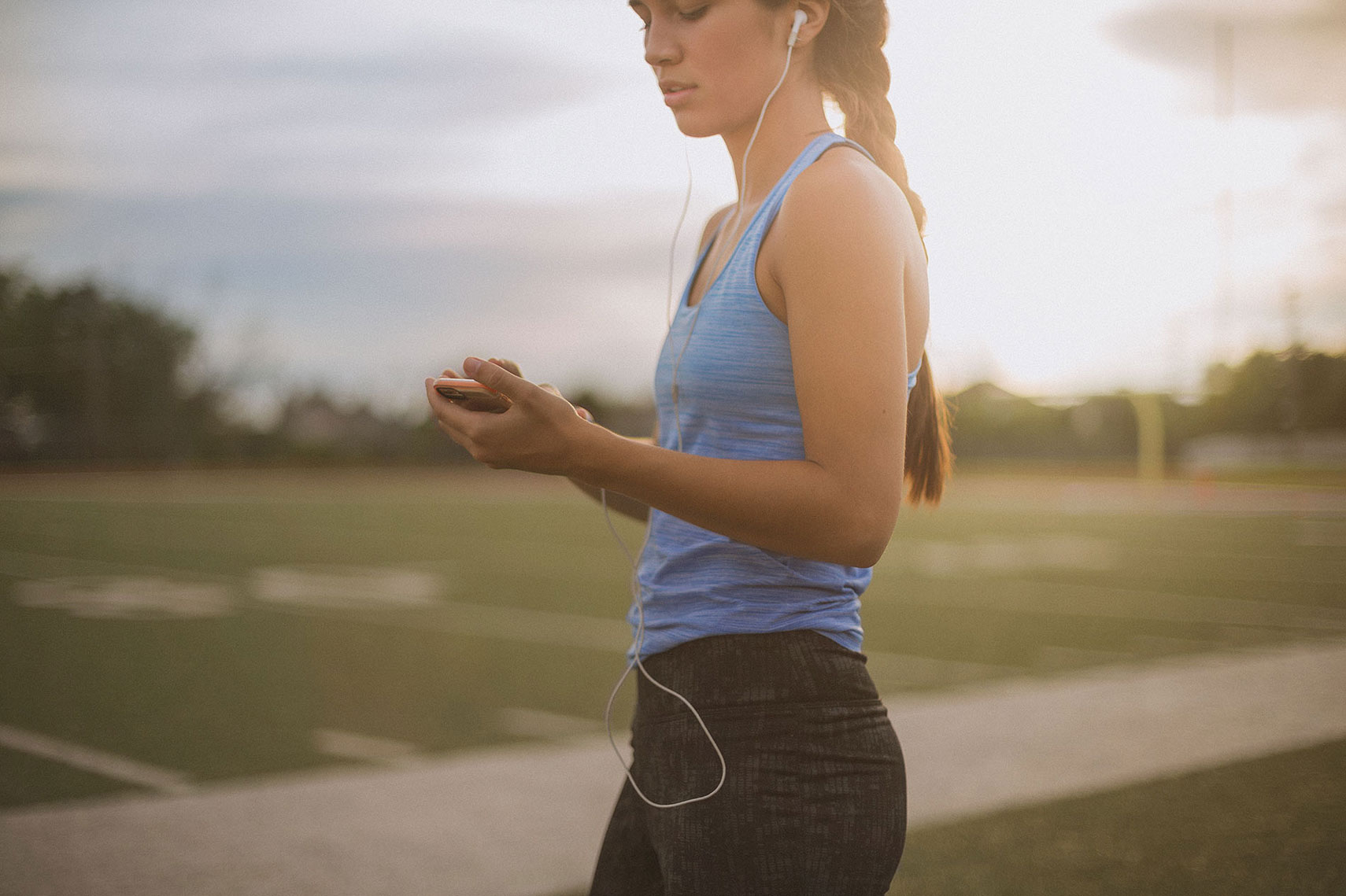Woman setting her phone before her workout. | John Fedele Lifestyle Photography