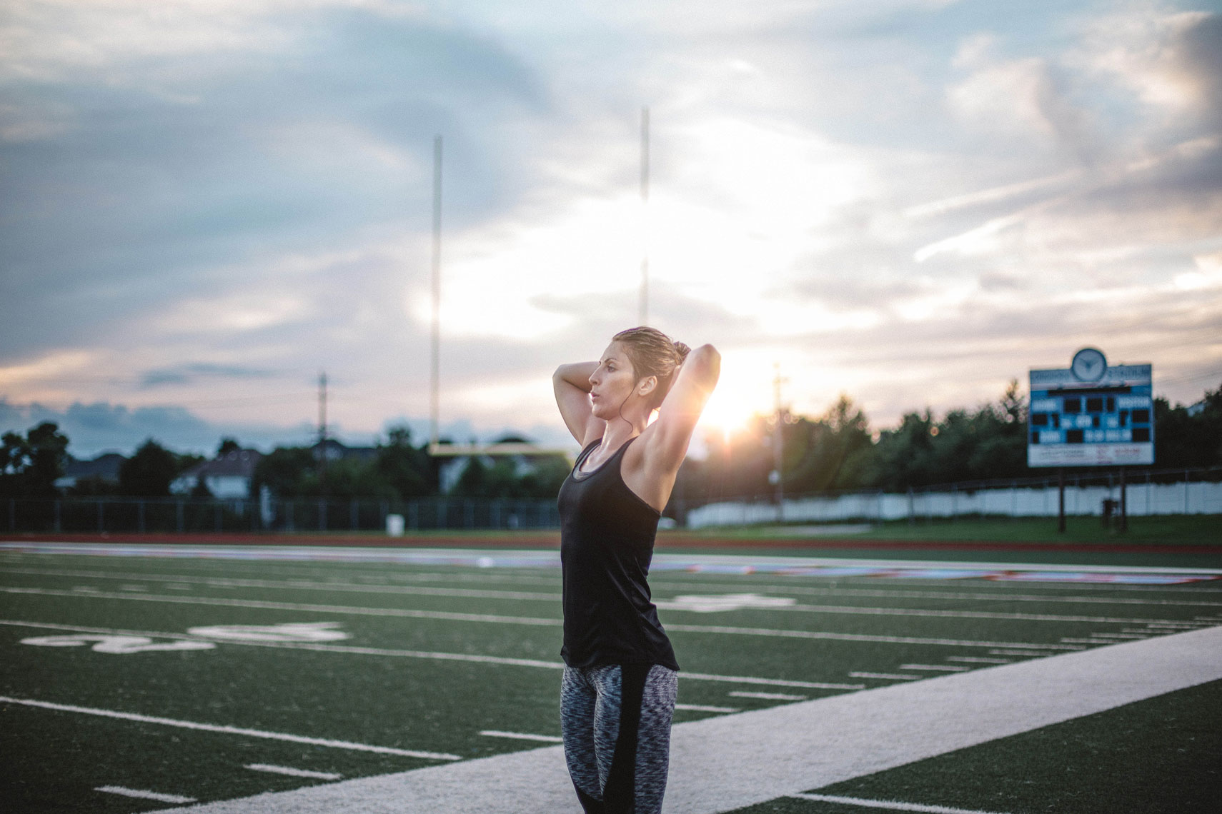 Women stretching on a football field. | John Fedele Lifestyle Photography