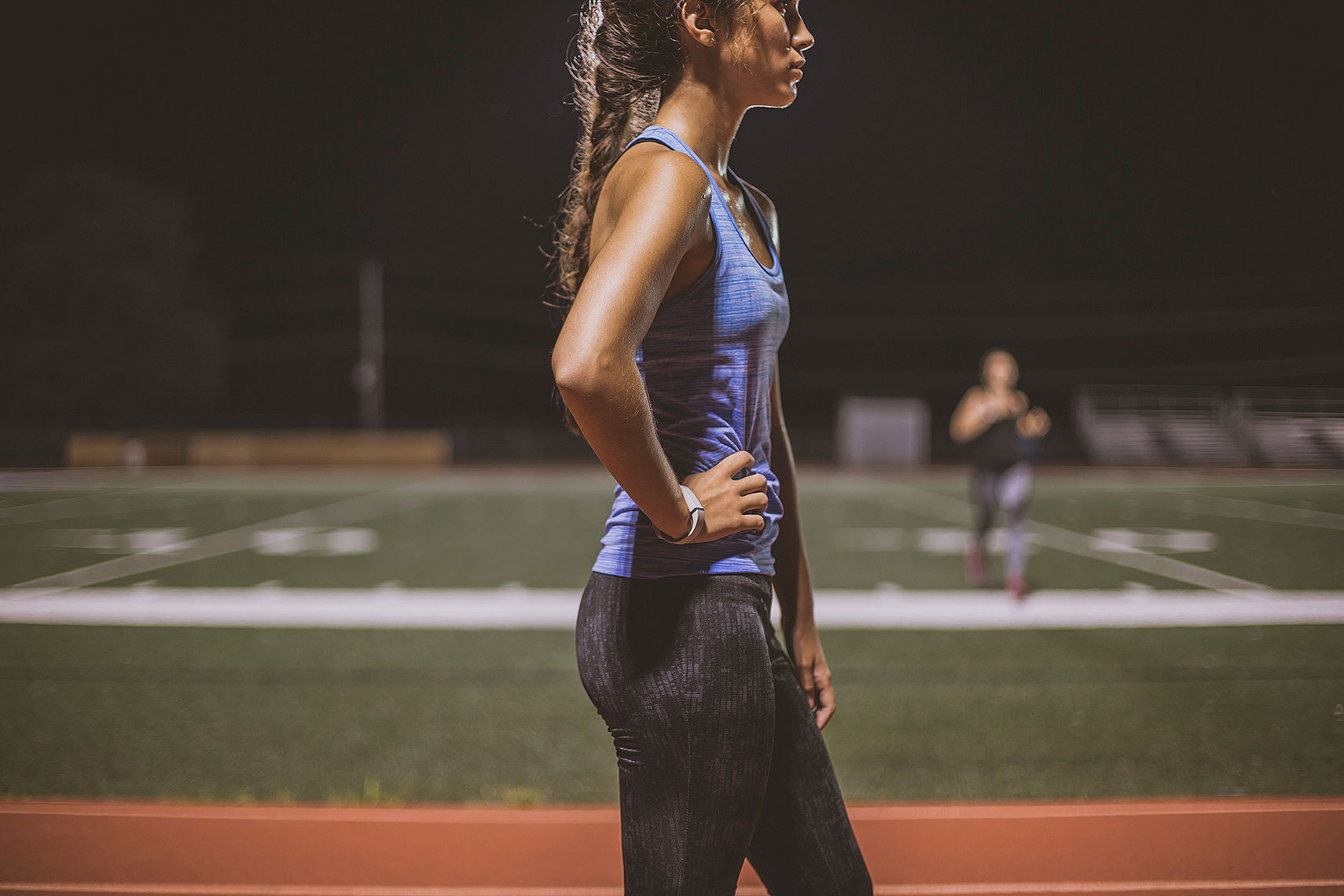 Two women on a track at night. | John Fedele Lifestyle Photography