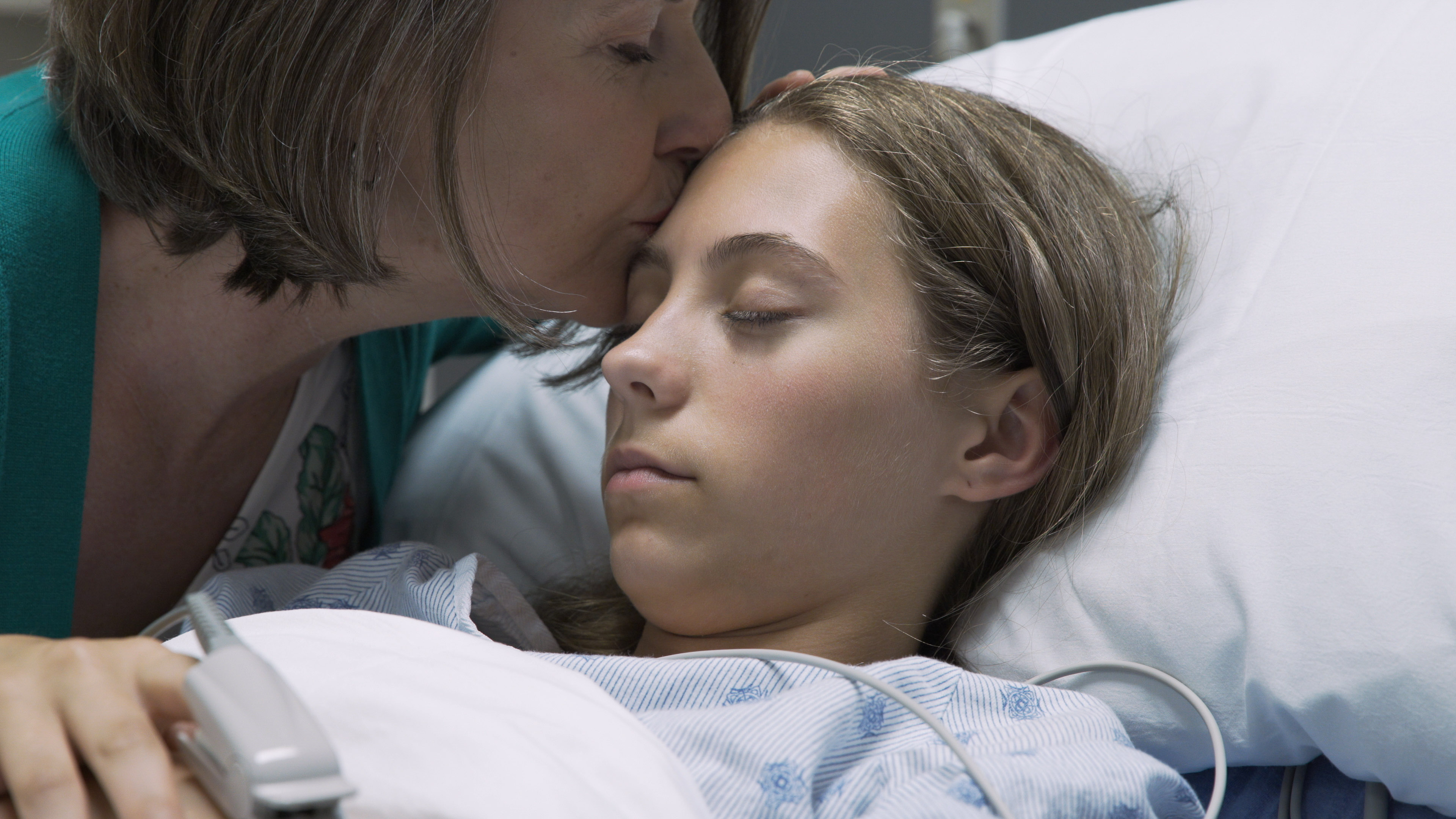 Mother Kissing Ill Daughter