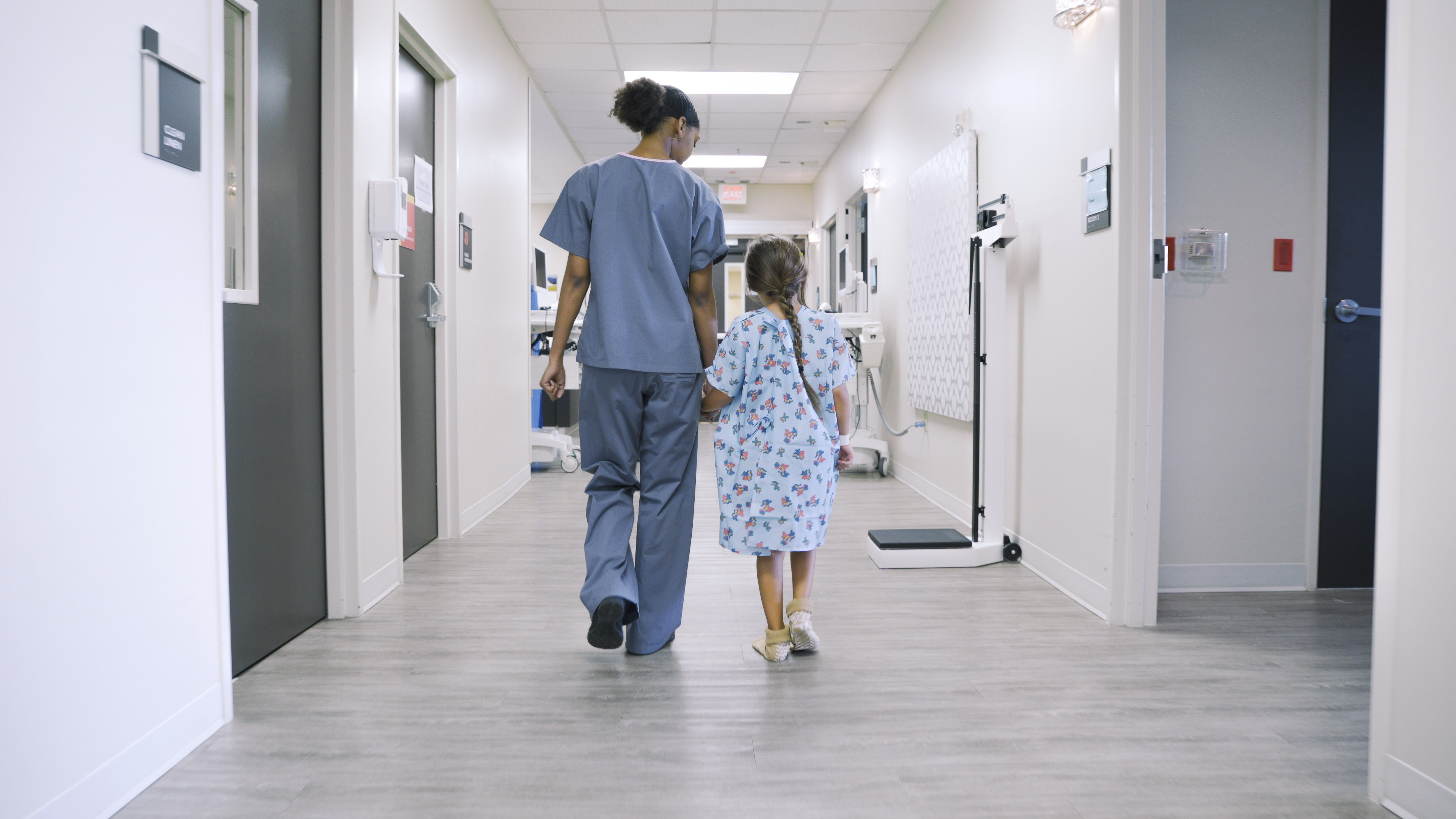 Nurse Holding  Hands with Child