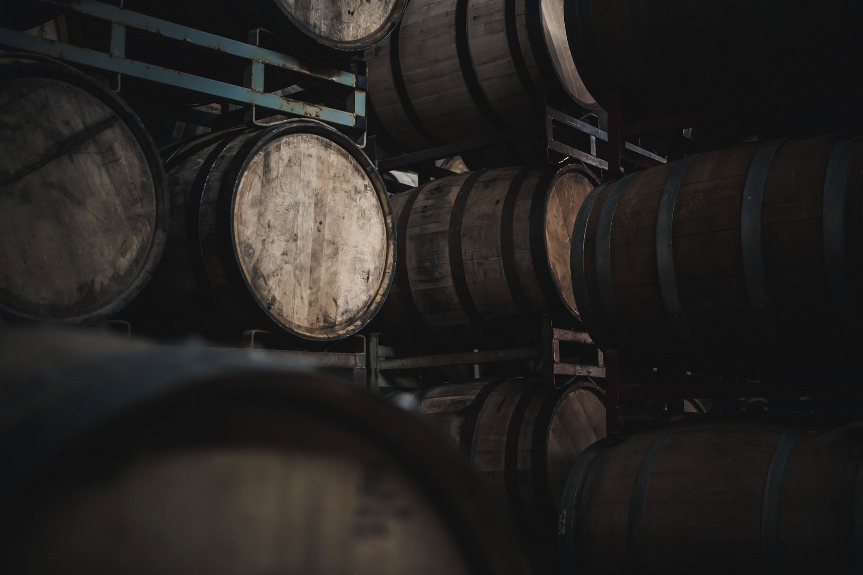 Aging whiskey barrels in a warehouse. | Side Project Brewery | John Fedele Photography 
