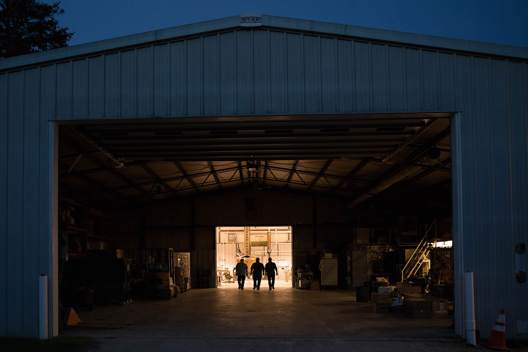 Three men walking through a barn | Whiskey Acres Distillery | John Fedele Agricultural Photography