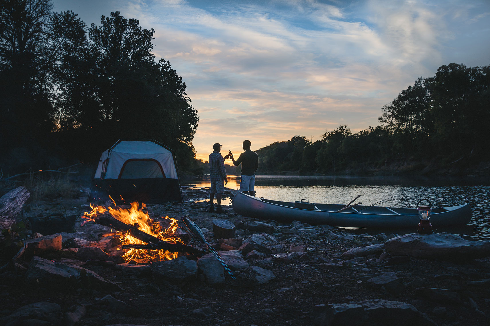 Two men cheers at their campsite. | John Fedele Lifestyle Photography