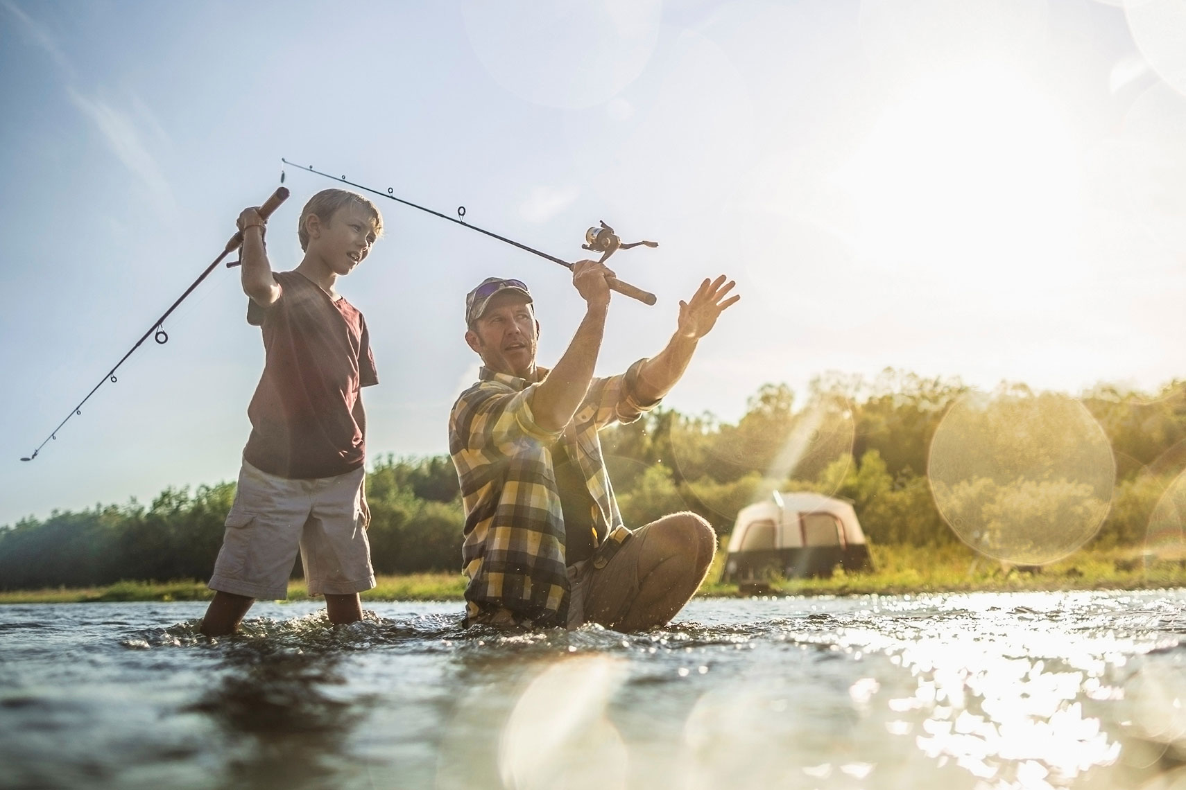 Father teaching his son to fish in a river.  | John Fedele Lifestyle Photography