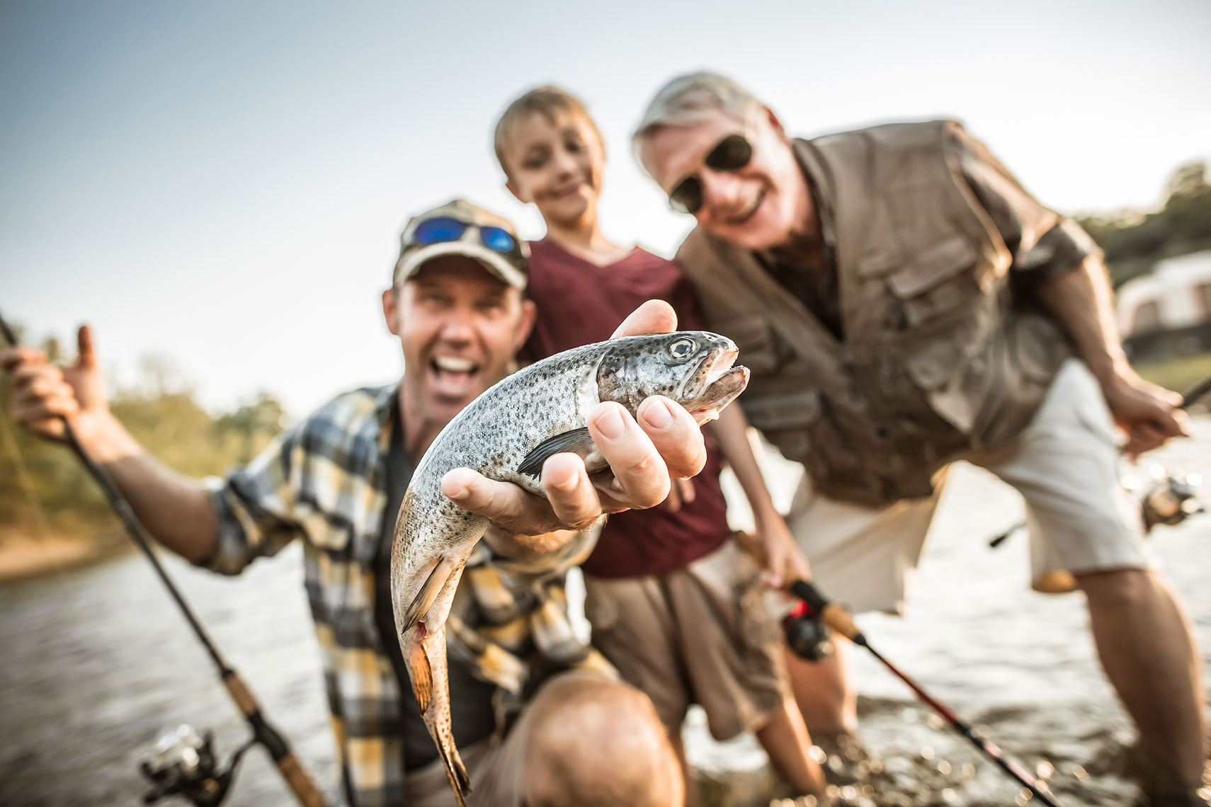 Father, son and grandfather showing off the fish they caught.  | John Fedele Lifestyle Photography